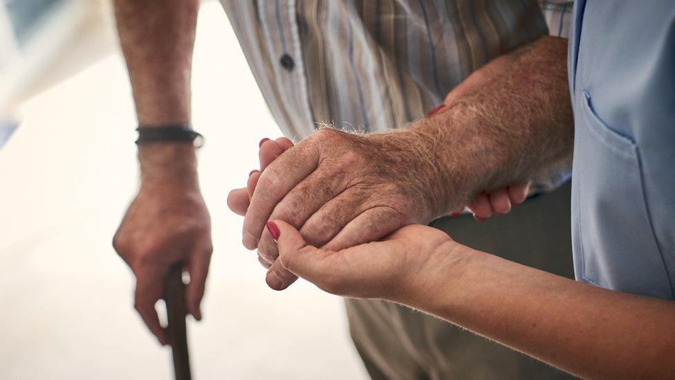 Woman holding man's hand