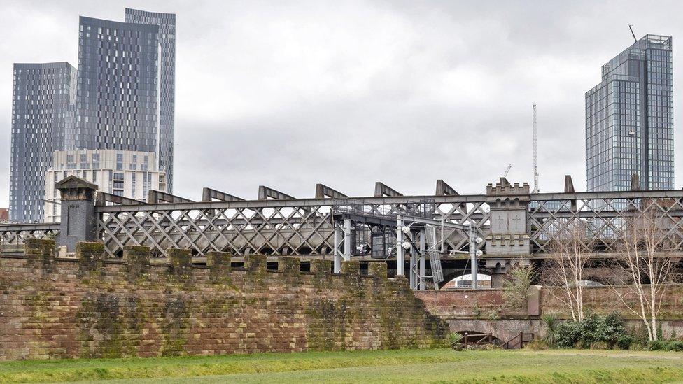 castlefield viaduct park with skyscrapers behind