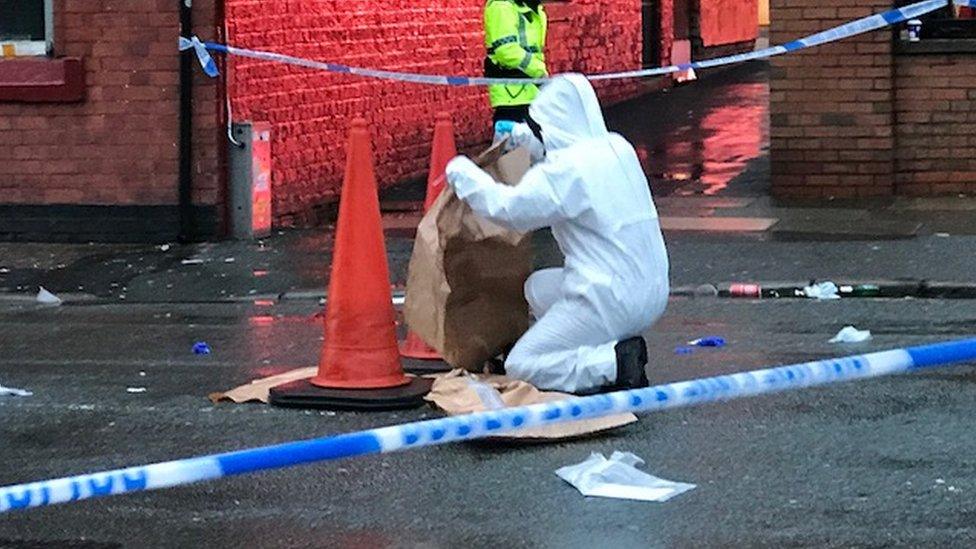 Man in forensic suit outside Anfield.