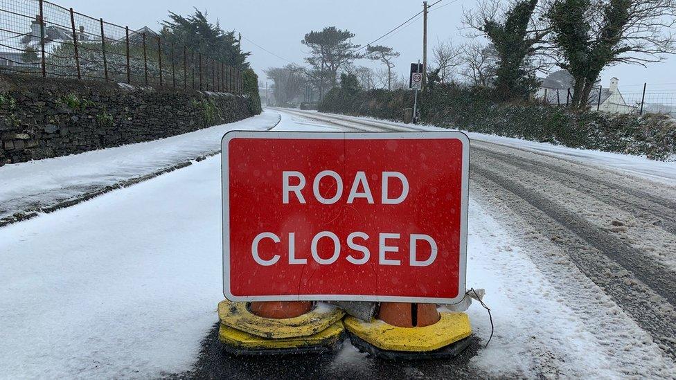 road closure sign on snowy road