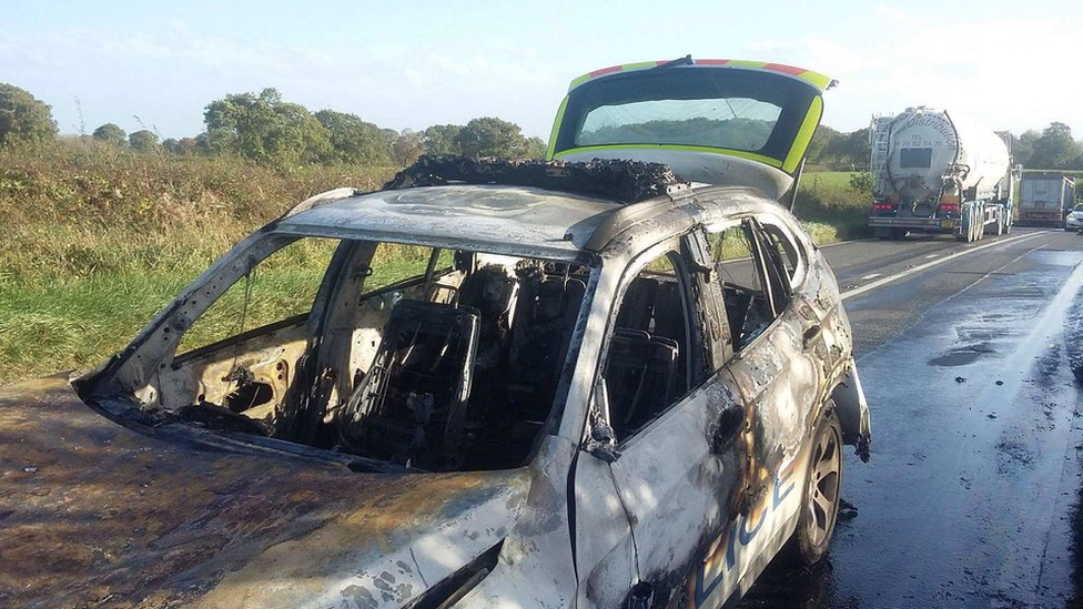 Burnt out police car