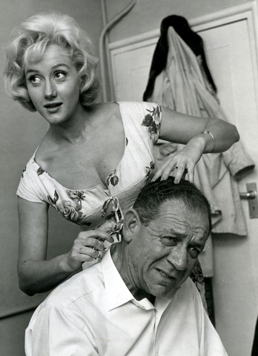 Liz Fraser taking scissors to the hair of Carry On co-star Sid James