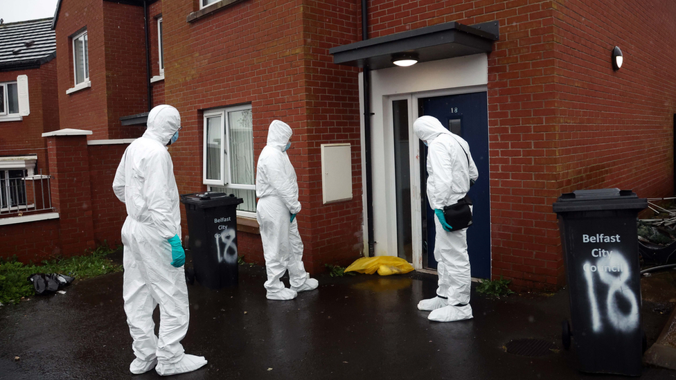 Forensics officers at an address in St Bernadette's Avenue