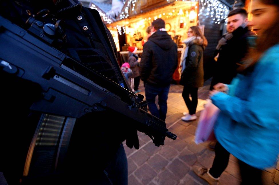 A French police officer patrols at the Christmas market in Reims, 20 December