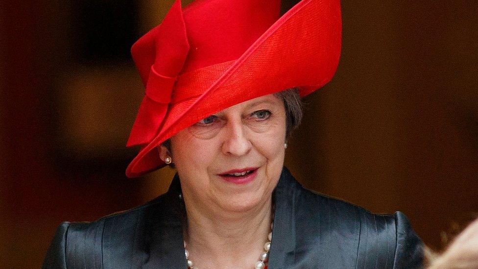 Theresa May leaves Downing Street in a bright red hat ahead of the service at Westminster Abbey