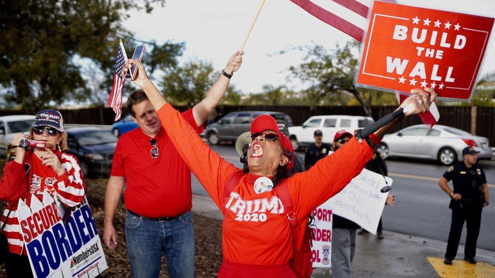 Pro-wall demonstrators show signs of support for President Donald Trump and a border wall in front of a Border Patrol station on January 12, 2019 in San Ysidro, California