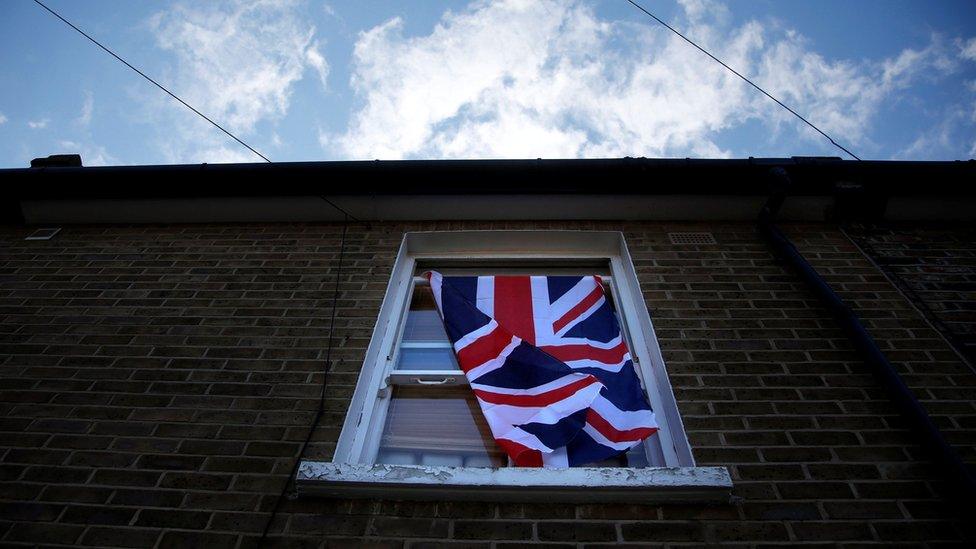 Union Jack hangs in window