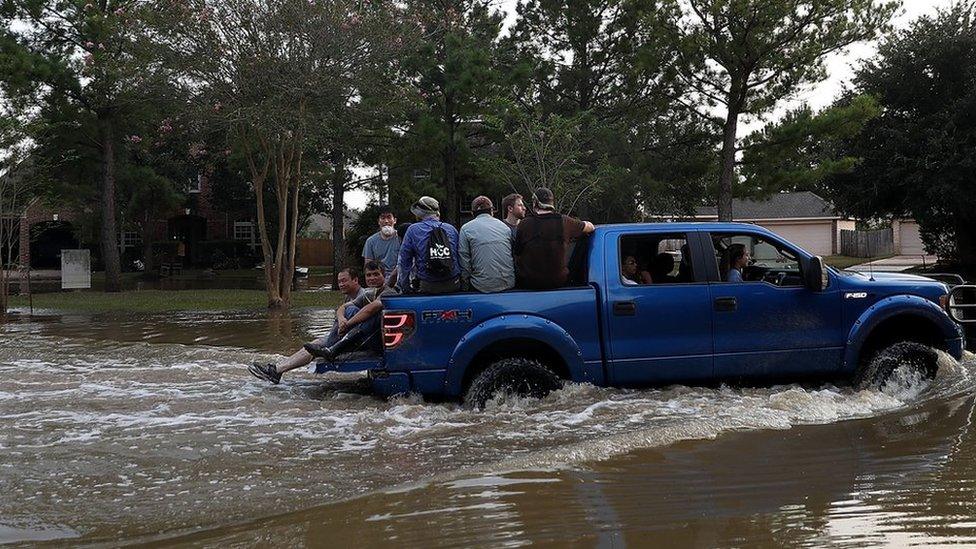 Houston flooded, car driving through water