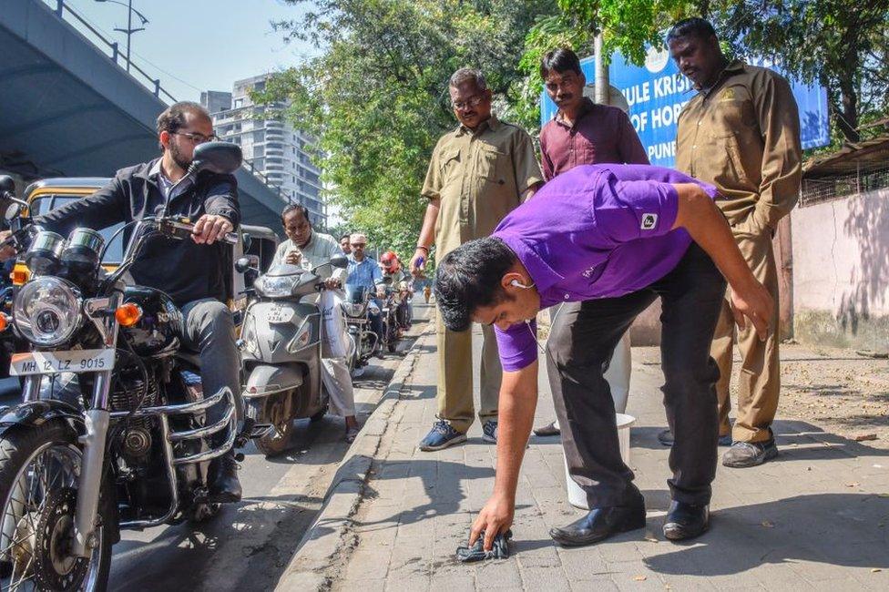 The anti-spitting squad of the Pune municipal corporation (PMC) took action against 11 persons, including three car drivers, during an Anti Spitting drive at Mhasoba Gate Chowk, on November 12, 2018 in Pune, India. The offenders were given a mop and made to clean their gutkha-laced spit.