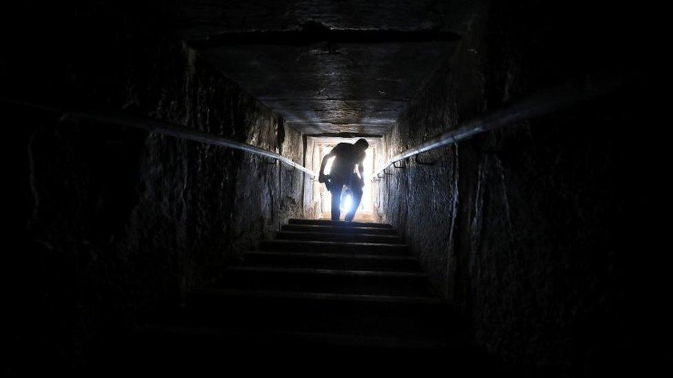 A man walks out of a passage from inside the Bent Pyramid. Photo: 13 July 2019