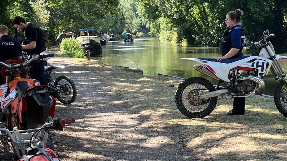 Police seizing the off road bikes besides the Kennet and Avon Canal