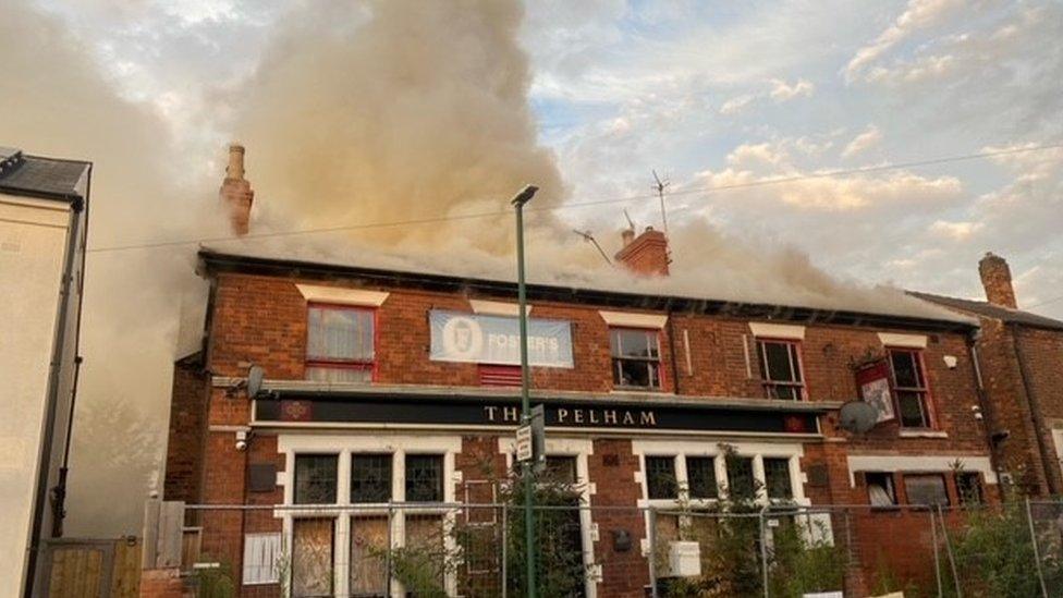 Smoke coming from the roof of the pub