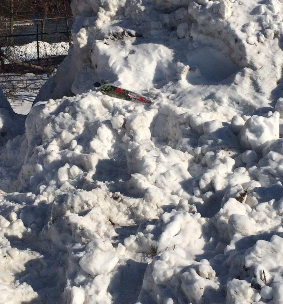 A rose was placed atop the snow mound on Wednesday