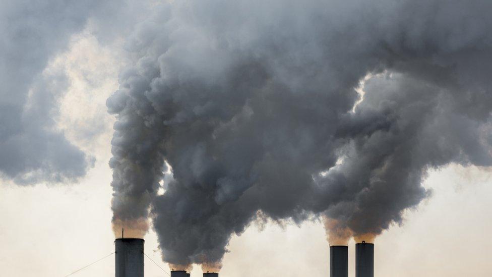 Smoke rises from industrial chimneys in Greece