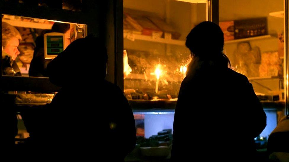 Small store operates by candlelight in town near Kyiv