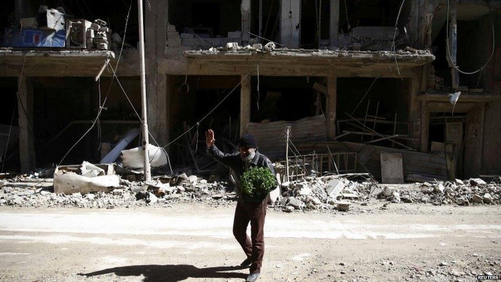 A man walking through the rubble in Eastern Ghouta