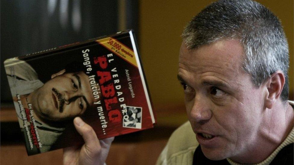 John Jairo Velasquez, a former hit man for Pablo Escobar, gives his testimony while holding a book titled "The True Pablo, Blood, Treason, and Death" on Tuesday, June 27, 2006.