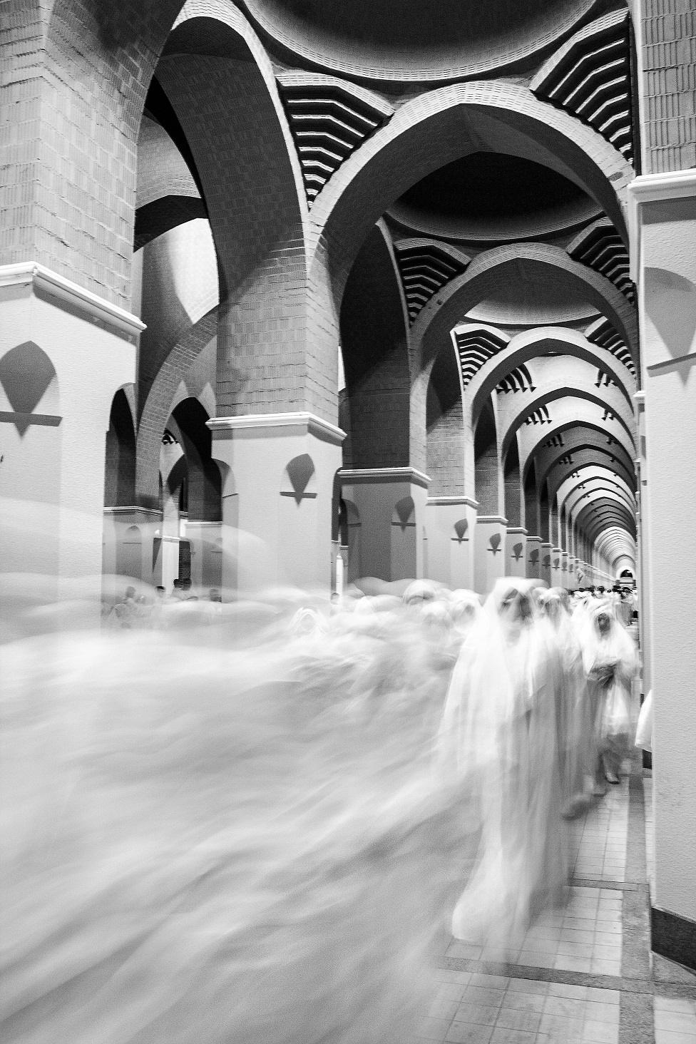 A long exposure photo of women walking down a corridor