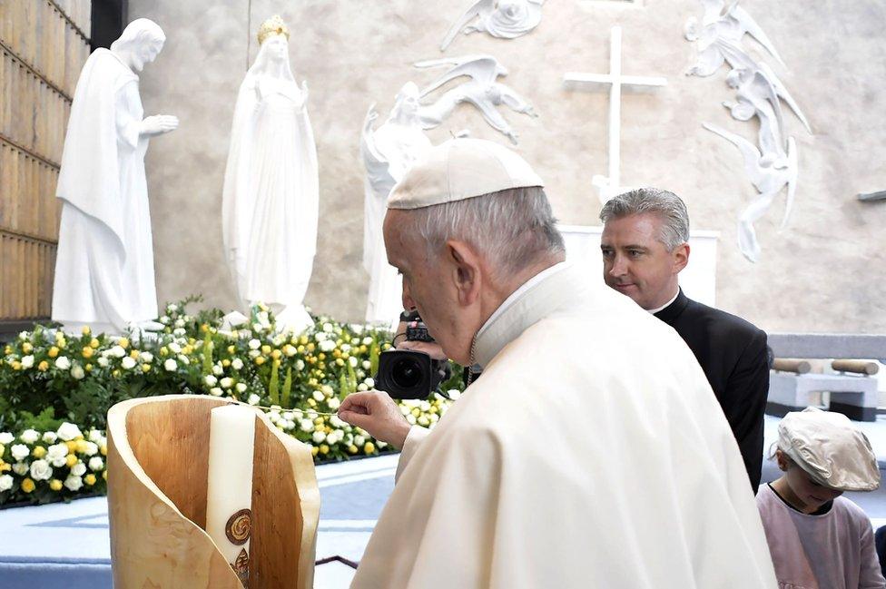 Pope Francis lights a candle at the Knock shrine