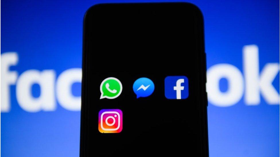 Mobile phone showing facebook logo and apps