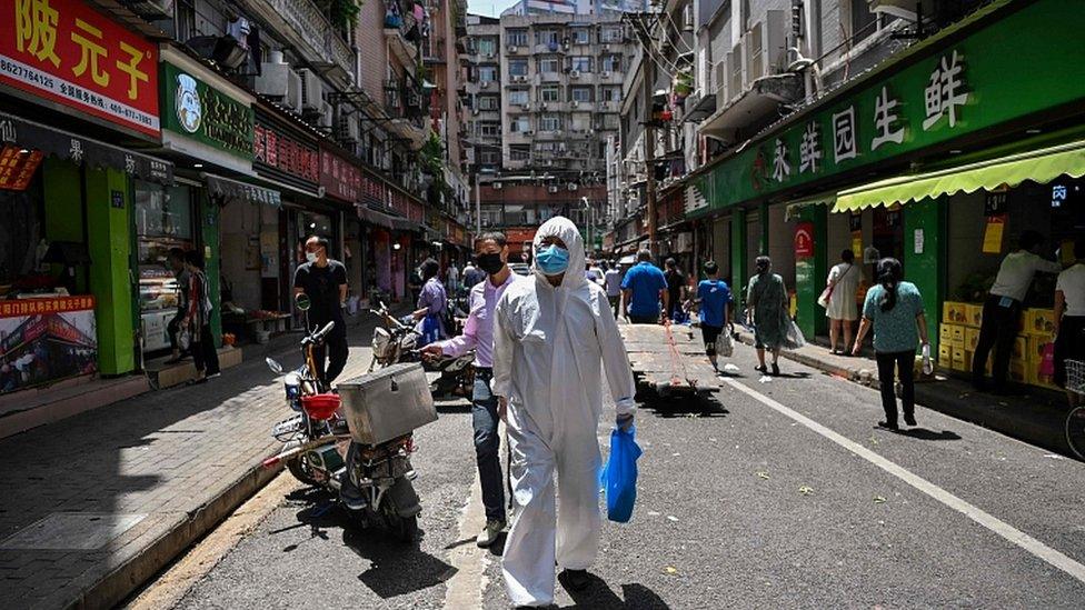 Street in Wuhan with person in protective clothing