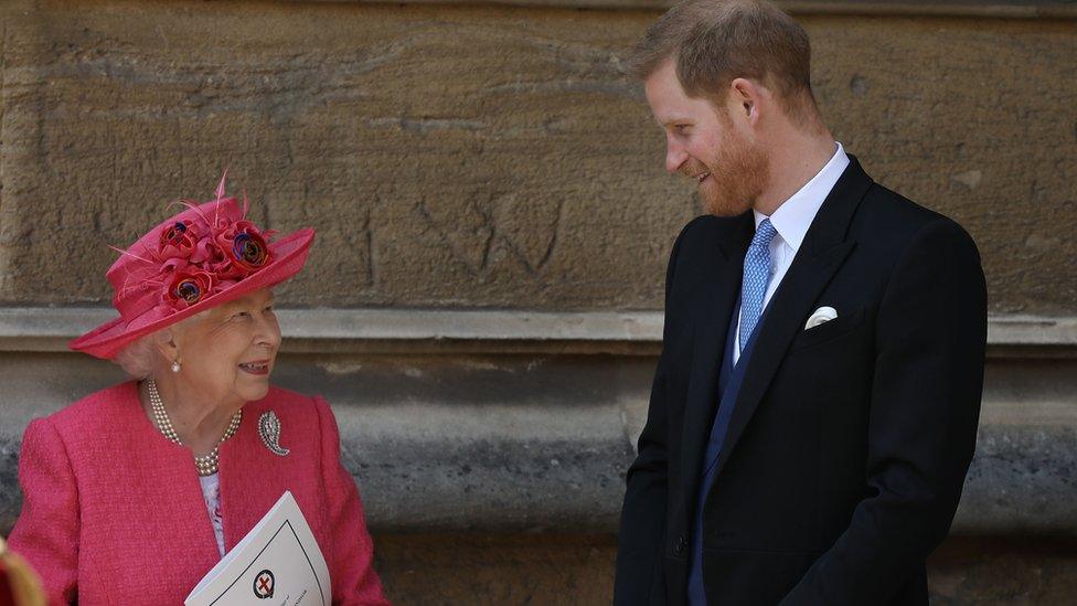 Britain's Queen Elizabeth II chats to Britain's Prince Harry, Duke of Sussex as they leave St George's Chapel in Windsor Castle, Windsor, west of London, on May 18, 2019, after the wedding ceremony of Lady Gabriella Windsor and Thomas Kingston