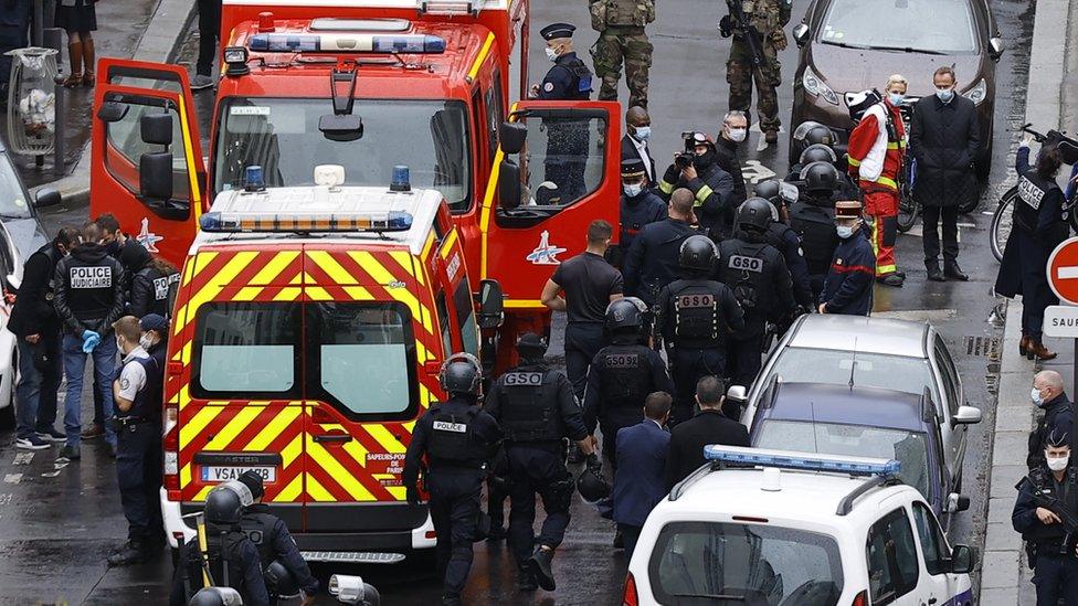 Emergency services work at the site of the knife attack near the former Charlie Hebdo offices in Paris