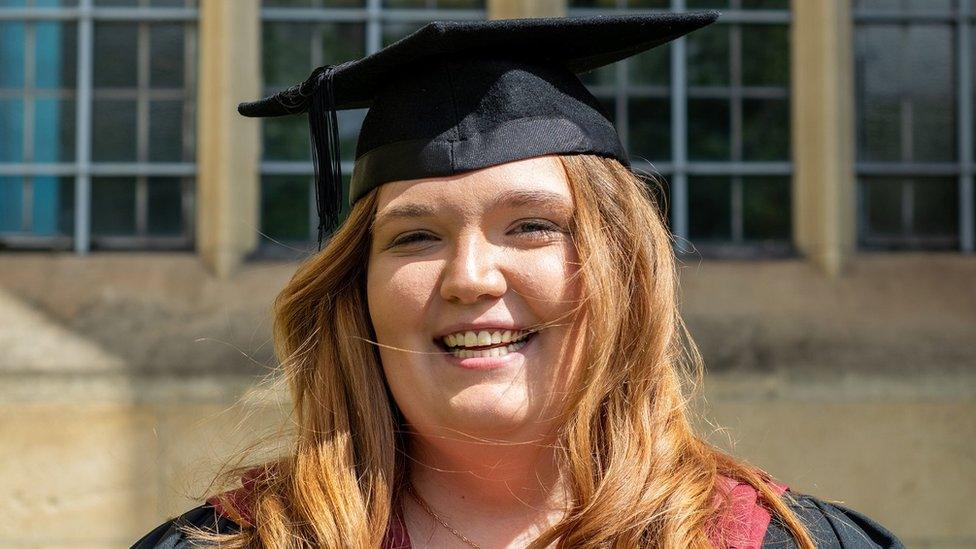 Chloe Fussell smiling wearing her graduation mortar board