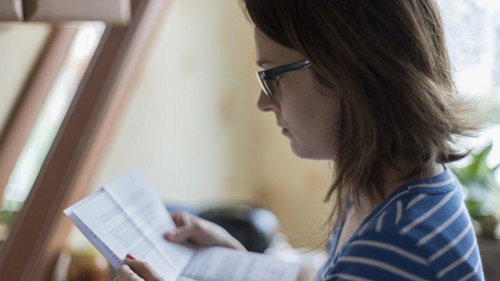 Young woman reading letter