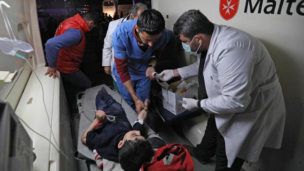 A Syrian boy is treated in an ambulance following his arrival in Qalaat al-Madiq, north-west of the city Hama, on 2 April 2018