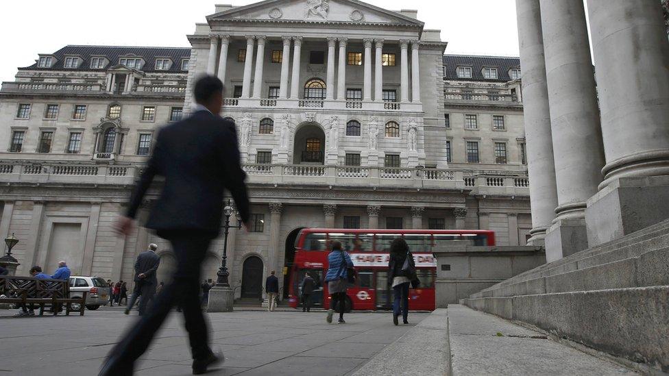 Commuters walk past the Bank of England in London