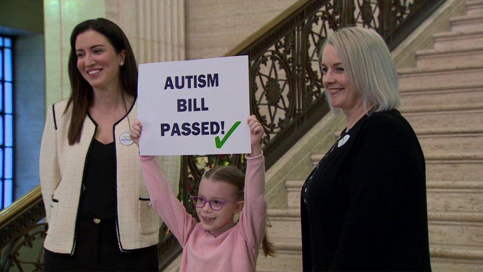 Pam Cameron and Kerry Boyd stand with a young girl