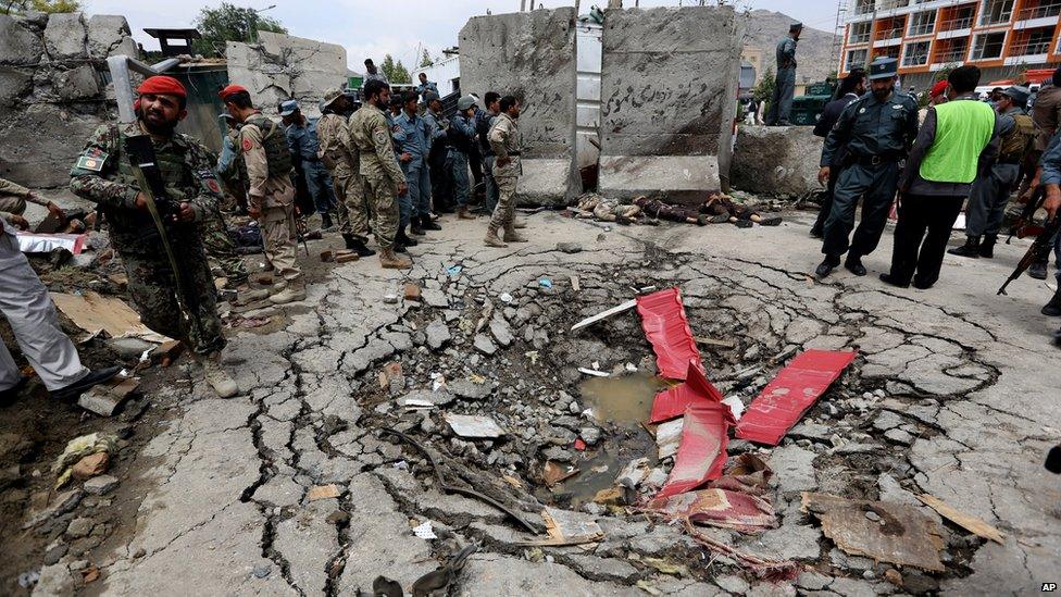 Afghan security forces gather near near the dead bodies of Taliban attackers in Kabul on 22 June 2015