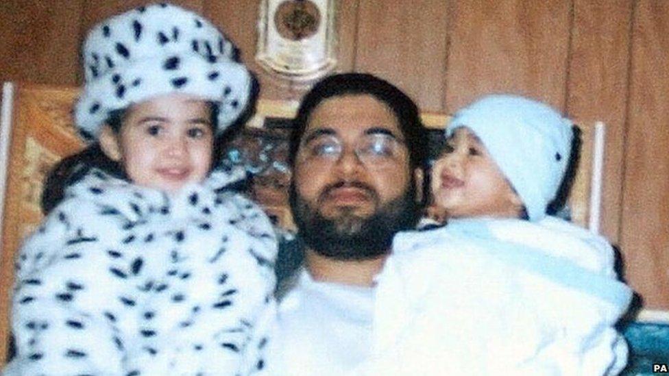 Shaker Aamer holding two of his children