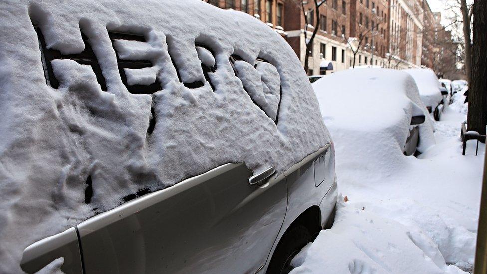 "help" written in snow on car