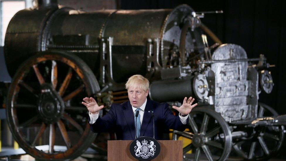 Prime Minister Boris Johnson speaking in front of engine at the museum