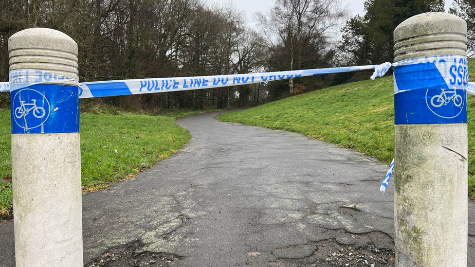 Police tape across bollards