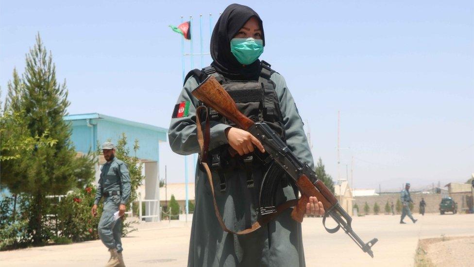 An Afghan police officer holding a rifle, May 2021