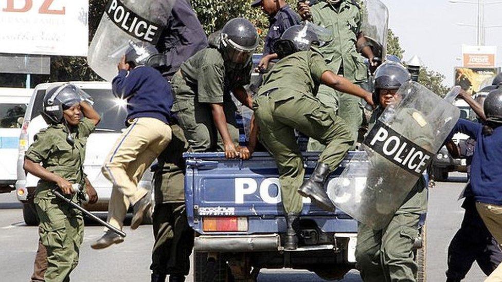 Zambian police officers arrive at the University of Zambia where students protest against the government’s removal of fuel and mealie meal subsidies on May 17, 2013 in Lusaka