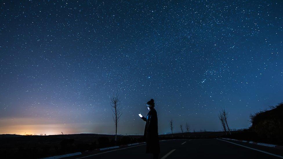 Stars in sky and girl texting