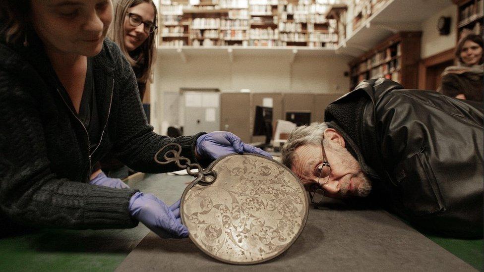 Michael Rosen inspects the Desborough Mirror - similar to the Portesham Mirror