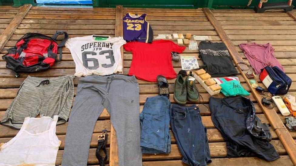 Clothes and other items found inside red rucksack