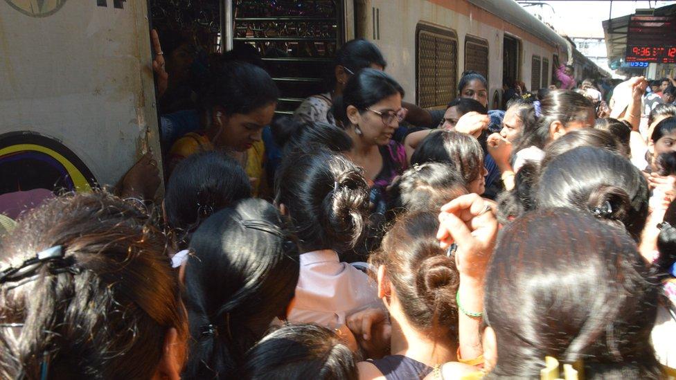 Women rushing to get into a train