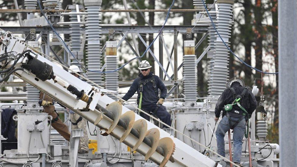 Workers repair damage after an attack on a power station in North Carolina in December 2022