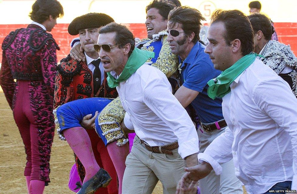 Spanish matador Francisco Rivera Ordonez "Paquirri" (C) is carried to the bullring infirmary by matador Juan Jose Padilla (C L), among others, after being seriously gored by a bull during the San Lorenzo fair in the northern Spanish town of Huesca on August 10, 2015.