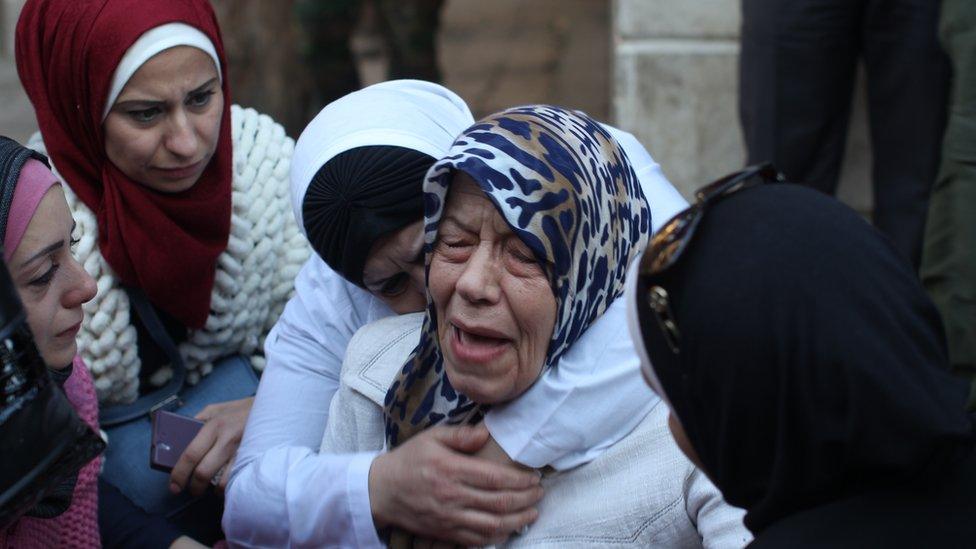 Grieving woman being comforted, 3 November 2016