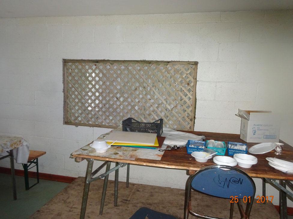 Messy looking desk in scruffy room, photographed by Ofsted in unregistered school