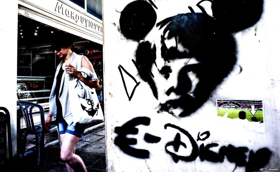 Graffiti showing German Chancellor Angela Merkel as a mouse to compare the European Union with Disney 15 June 2015