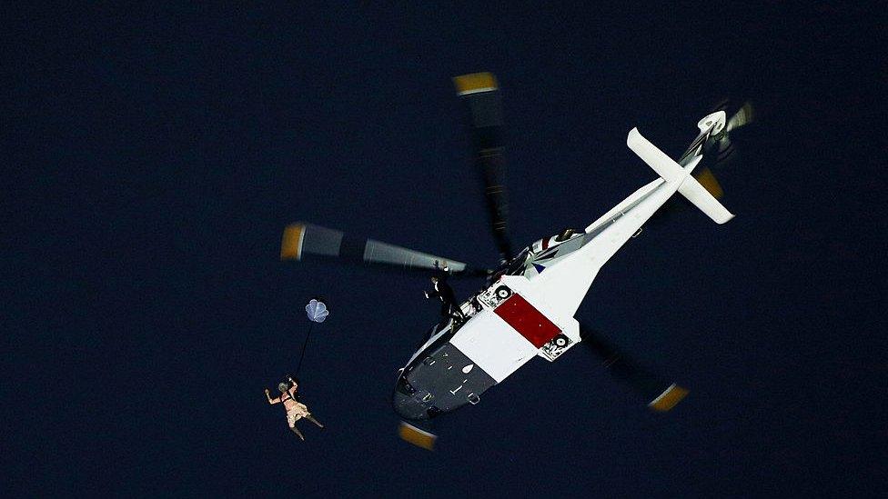 A stunt-double of The Queen parachutes from a helicopter during the 2012 Olympic opening ceremony in London.