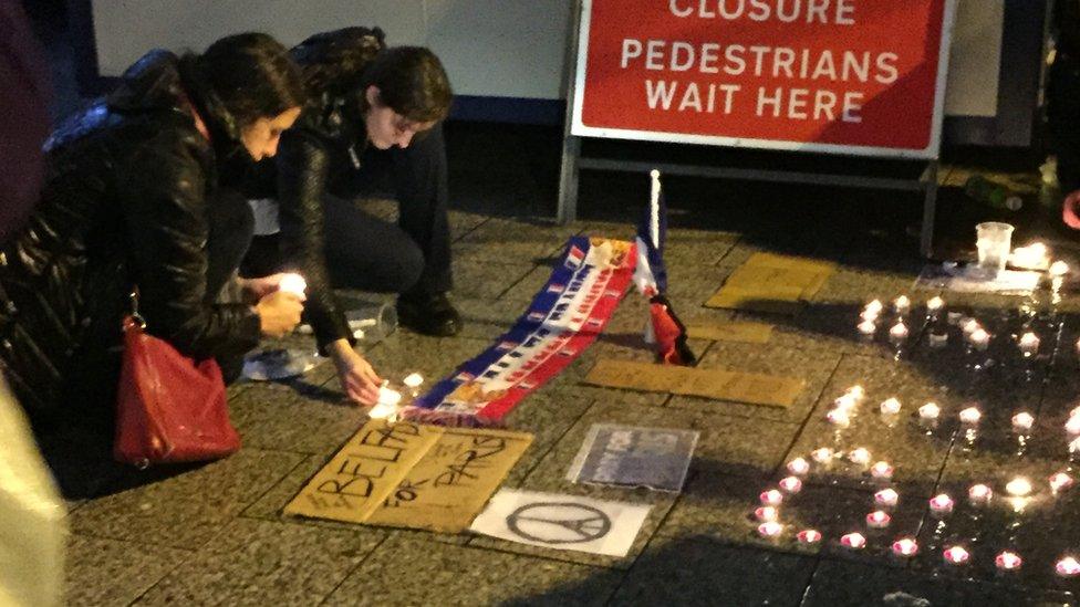 People lighting candles outside Belfast City Hall